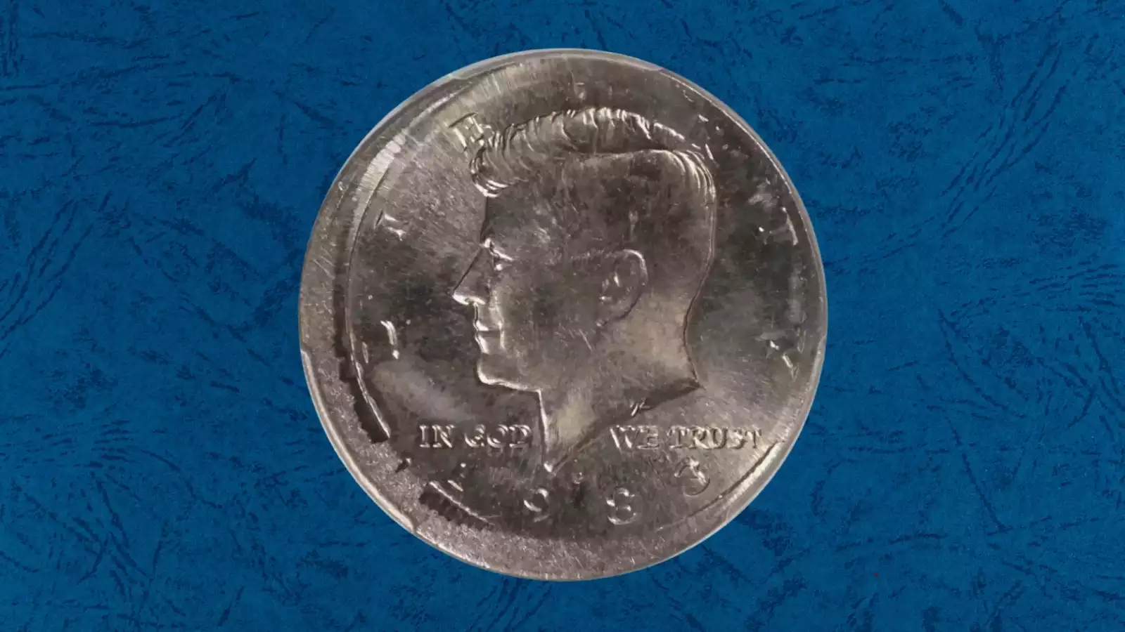 1983-P Kennedy Half Dollar off-center strike error showing design shifted to one side with blank crescent area